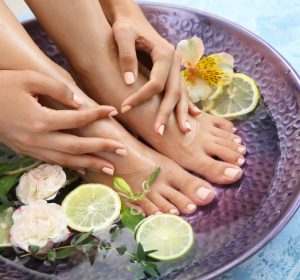 Young woman undergoing spa pedicure treatment in beauty salon