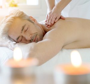 Man relaxing on massage table receiving massage